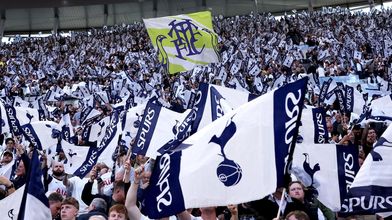Fans wave flags ahead in the South Stand ahead of Brighton match in April