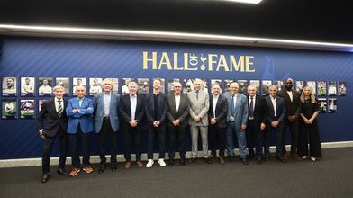 Hall of Fame inductees in front of our new wall installation at the stadium